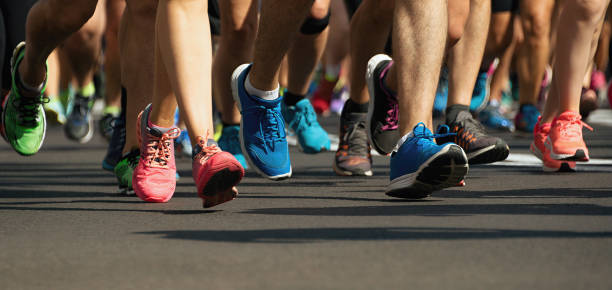 marathon runners running on city road,detail on legs